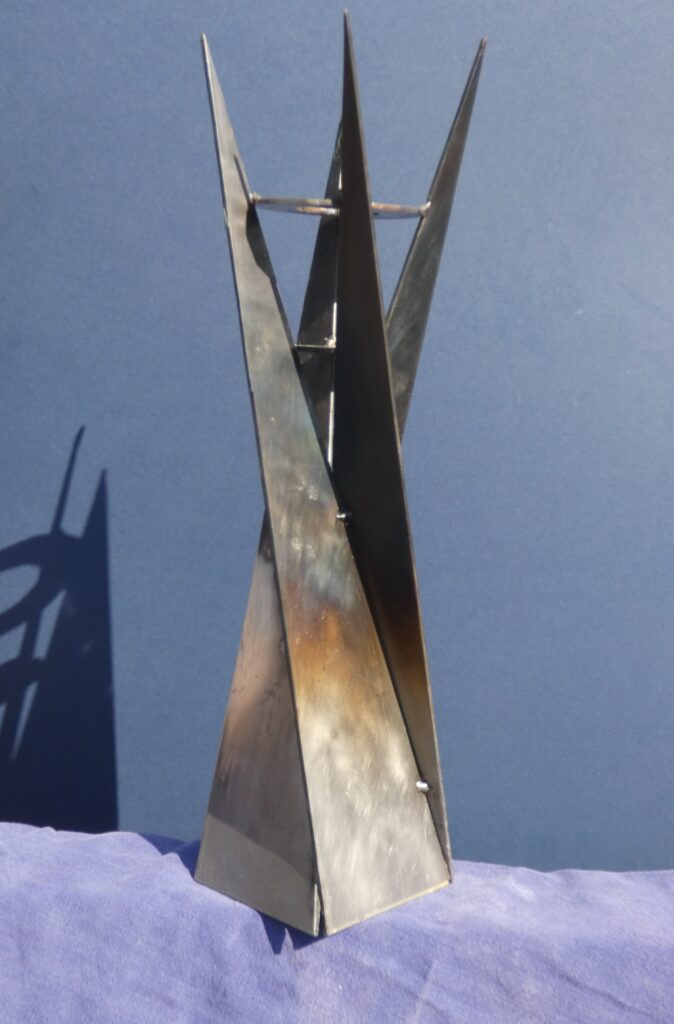 A steel tower, in bright sunlight producing dramatic shadows.